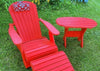 red Adirondack chair and side table on lawn